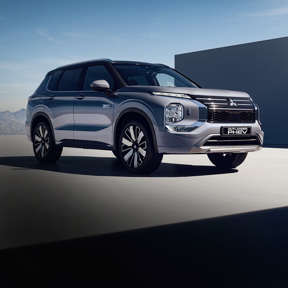 Person reversing out of a driveway in the 2026 Mitsubishi Outlander SUV using the multi view camera system