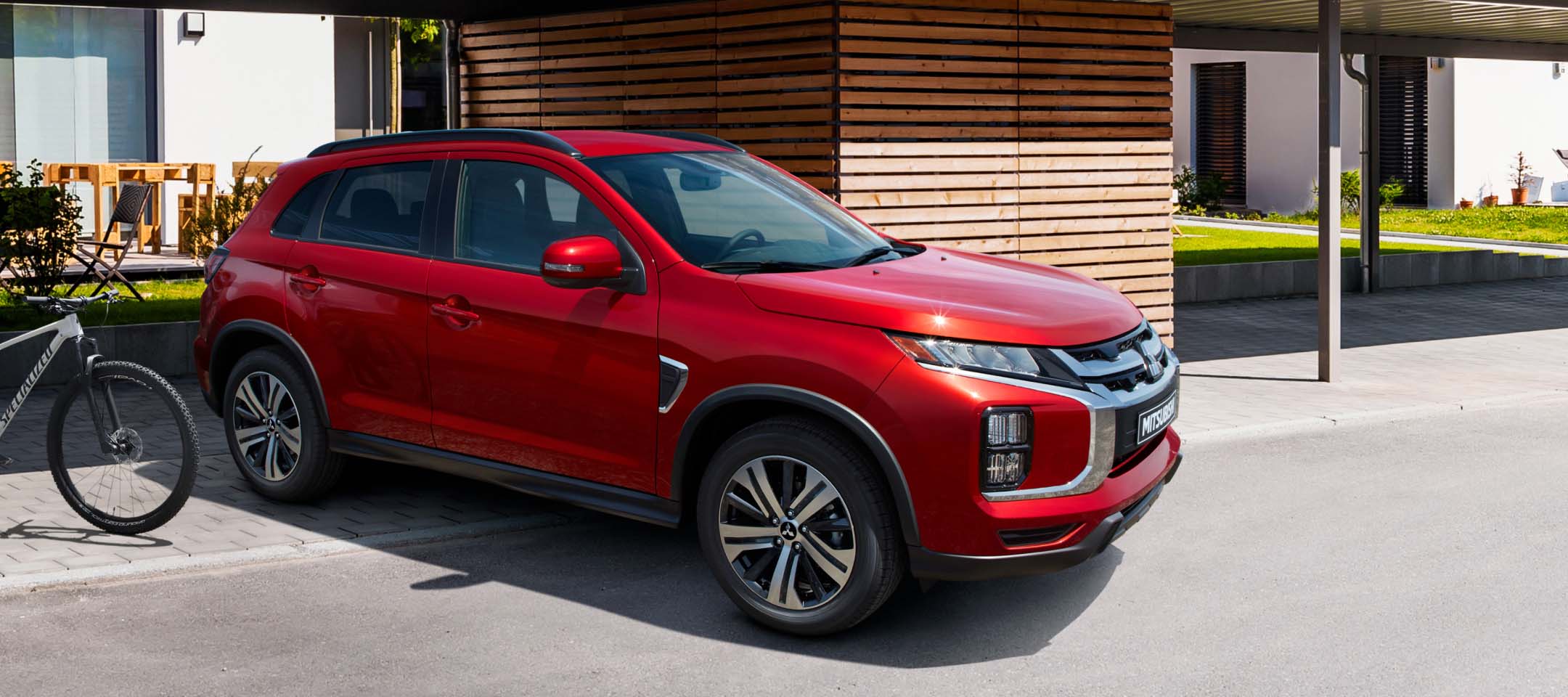 A red 2023 Mitsubishi Outlander Sport parked