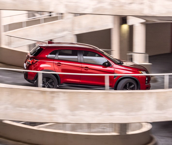 A red 2025 Mitsubishi Outlander Sport SUV with All-Wheel Control (AWC)
