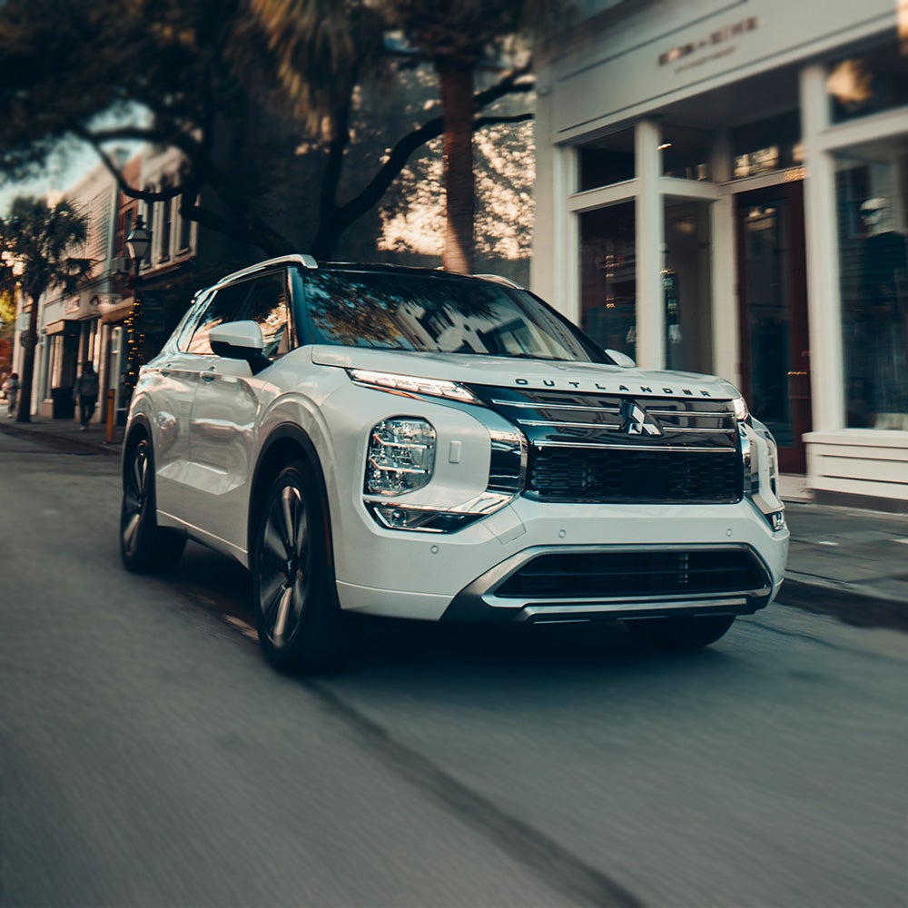 White 2026 Mitsubishi Outlander SUV driving on a road