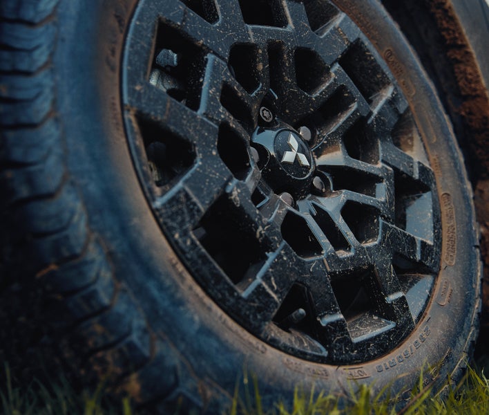 2025 Mitsubishi Outlander Trail Edition SUV with a black alloy wheel