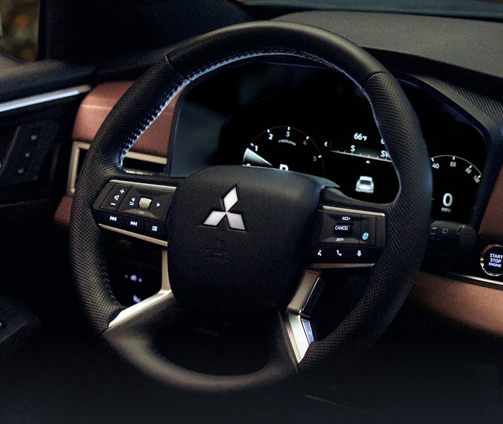 Close up on the steering wheel for the 2026 Mitsubishi Outlander SUV showing off the electric power steering feature